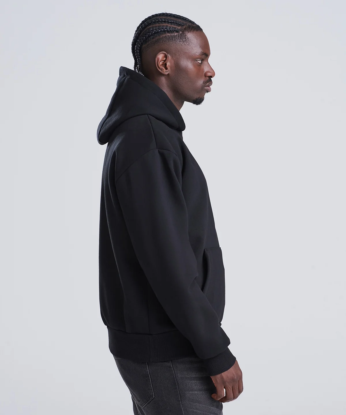 The Signature hoodie in black, side profile